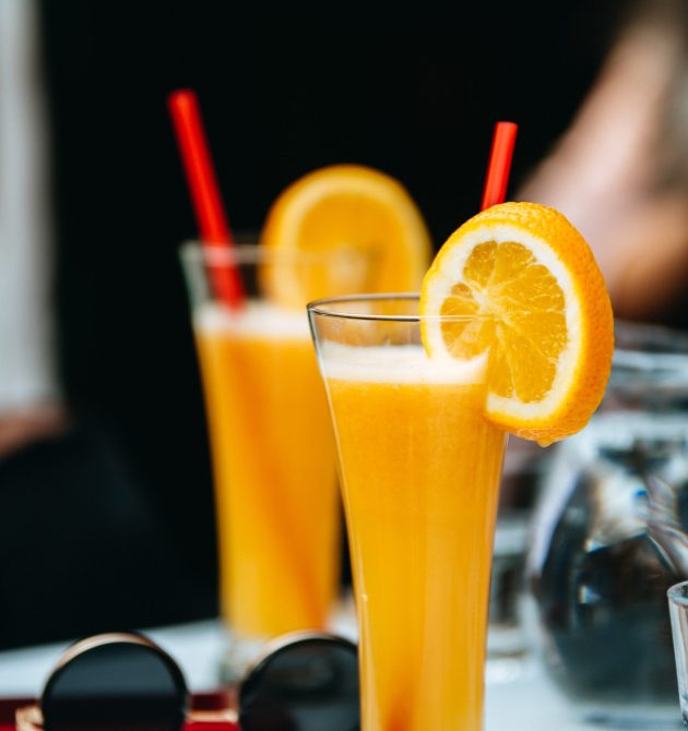 A vertical shot of delicious fresh orange juices in the cafe